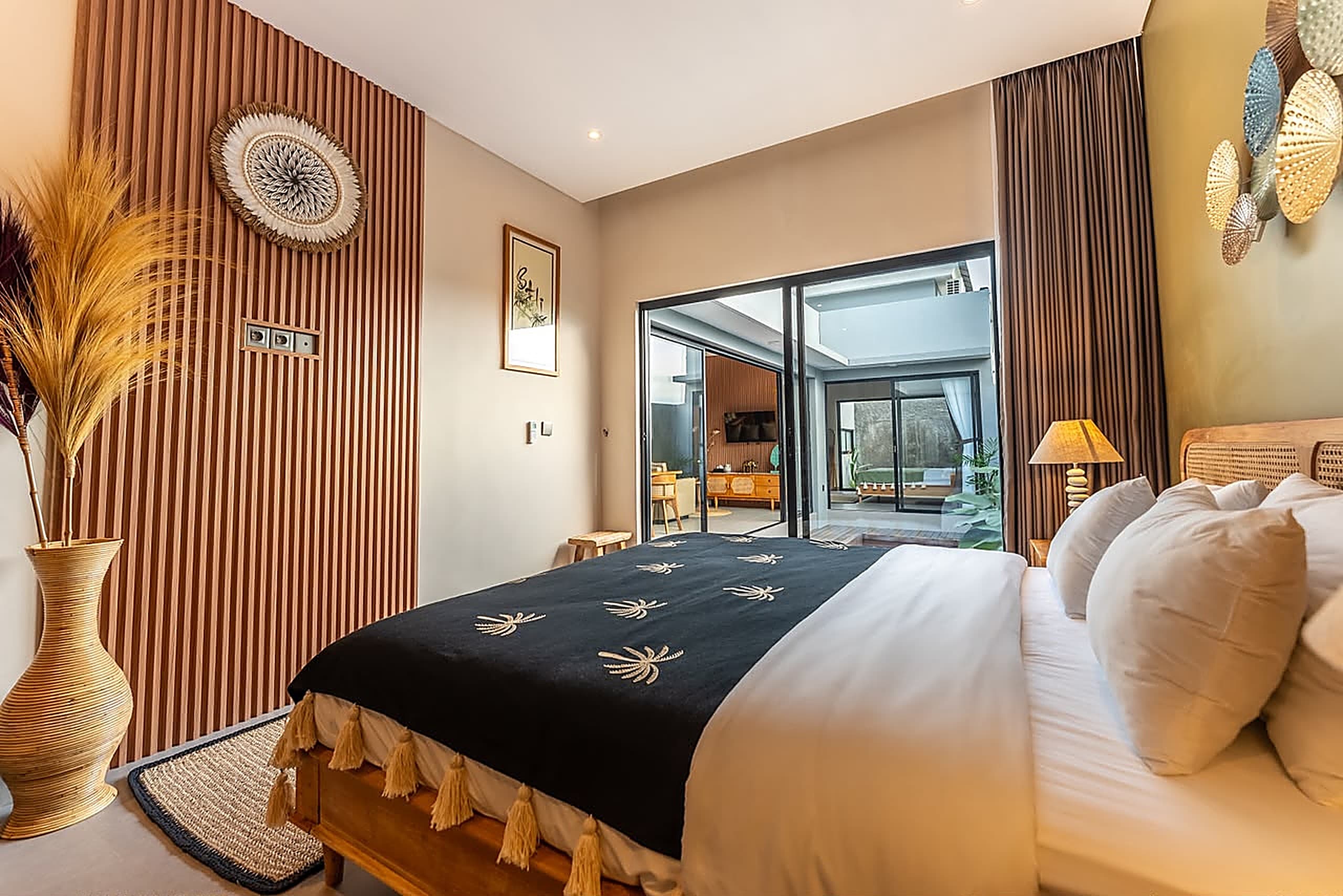 Olive Suite bedroom with slatted timber wall and pool view