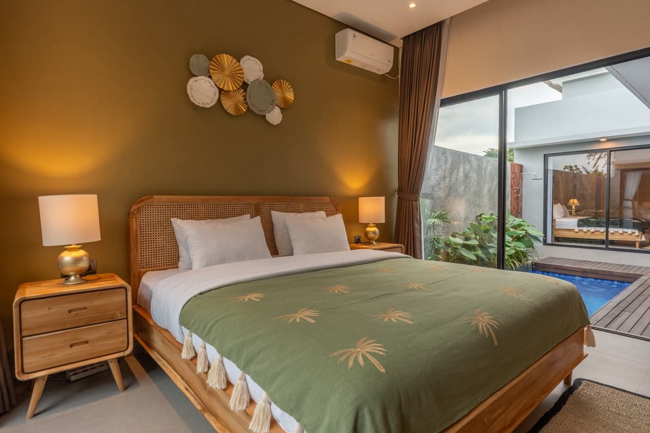 Garden Suite bedroom with pool view through sliding doors